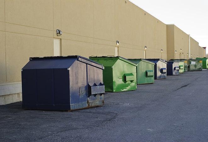 a fleet of red and blue construction dumpsters available for use in Auburn, GA